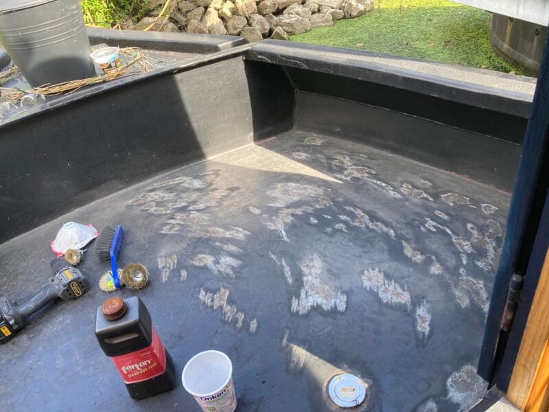 wirebrush on drill removing rust on narrowboat deck